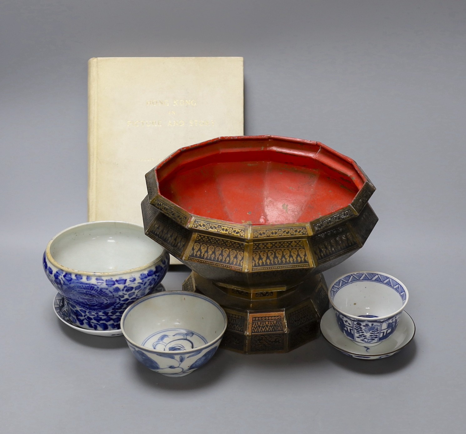 A collection of Chinese blue and white tea bowls, a vase, metal planter and book on Hong Kong by John and Veronica Stericker, (7)